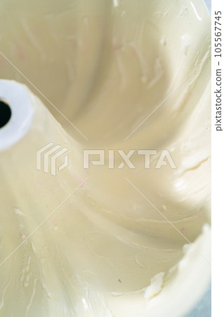Close up view. Greasing bundt cake pan with vegetable shortening and flour to bake funfettti bundt cake. 105567745