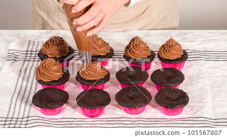 Step by step. Piping chocolate ganache frosting on top of chocolate cupcakes. 105567807