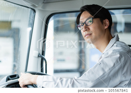 Young male driver driving a heavy truck 105567841