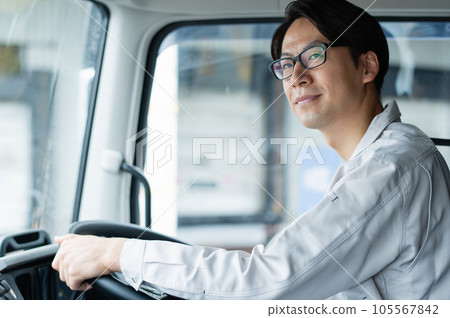 Young male driver driving a heavy truck 105567842