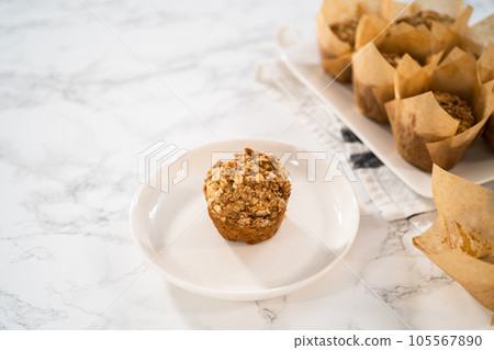 Freshly baked banana oatmeal muffins with oatmeal sugar topping. 105567890