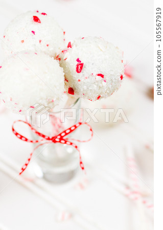 Peppermint chocolate cake pops dipped in white chocolate and candy cane bits. Peppermint chocolate cake pops dipped in white chocolate and candy cane bits. 105567919
