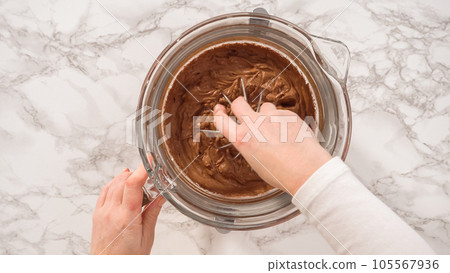 Flat lay. Step by step. Whipping chocolate ganache with an electric kitchen mixer. 105567936
