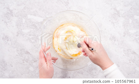 Flat lay. Step by step. Mixing ingredients in a glass mixing bowl to prepare red velvet bundt cake. Flat lay. Step by step. Mixing ingredients in a glass mixing bowl to prepare red velvet bundt cake. 105567961