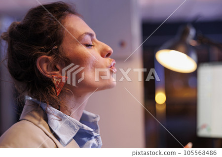 Cheerful corporate employee blowing air kisses in startup office, working overtime at investment strategy to increase company profit. Positive businesswoman analyzing marketing statistics Cheerful corporate employee blowing air kisses in startup office, working overtime at investment strategy to increase company profit. Positive businesswoman analyzing marketing statistics 105568486