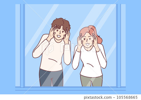 Man and woman look through glass showcase to examine product they like or follow customers of store 105568665