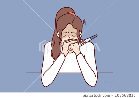 Frustrated pregnancy woman is crying holding pregnancy test with two strips and sitting at table Frustrated pregnancy woman is crying holding pregnancy test with two strips and sitting at table 105568833