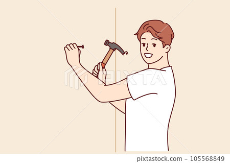 Man with hammer makes repairs in house by hammering nail into wall to hang picture Man with hammer makes repairs in house by hammering nail into wall to hang picture 105568849