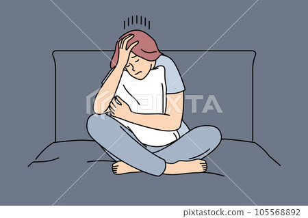 Melancholic woman is sad sitting on bed and hugging pillow after quarrel with boyfriend 105568892