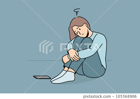 Sad woman is waiting for phone call, sitting on floor and suffering from loneliness or lack friends 105568906