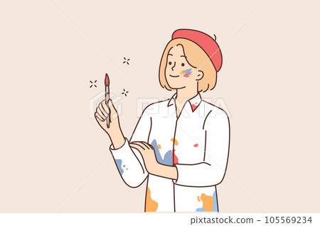 Woman artist in shirt stained with paint holds brush and looks to side waiting for inspiration 105569234
