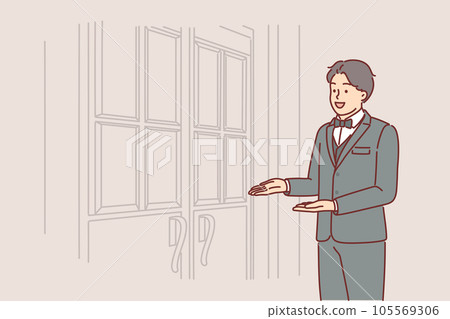 Man porter stands at door of restaurant inviting you to enter and saying welcome to guests Man porter stands at door of restaurant inviting you to enter and saying welcome to guests 105569306