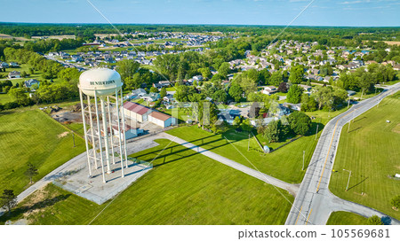 Long shadow cast by tall white Huntertown water tower in summer 105569681