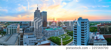 Panorama aerial downtown Fort Wayne golden morning sunrise breaking into brilliant blue skies Panorama aerial downtown Fort Wayne golden morning sunrise breaking into brilliant blue skies 105569700