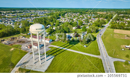 Aerial white Huntertown water tower on summer day with distant neighborhoods 105569731