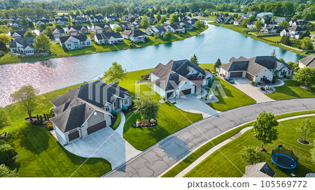Large houses next to pond view and trampoline neighborhood aerial Large houses next to pond view and trampoline neighborhood aerial 105569772