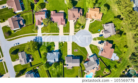 Aerial downward view rooftops suburban homes with green summer lawns Aerial downward view rooftops suburban homes with green summer lawns 105569776