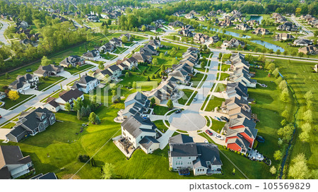 Red, orange house in rich neighborhood aerial with ponds mini mansion lush green landscaping Red, orange house in rich neighborhood aerial with ponds mini mansion lush green landscaping 105569829