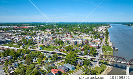 Aerial over ohio river iron arch bridge suspense highway cutting through town city Kentucky 105569891