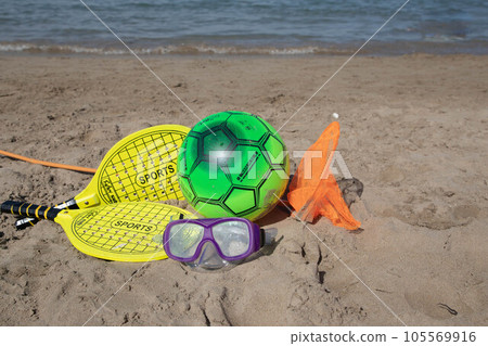 Beach tennis racket and ball, swimming mask ,and beach playing ball on tne beach Beach tennis racket and ball, swimming mask ,and beach playing ball on tne beach 105569916
