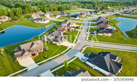 Rich expensive neighborhood aerial with mini mansions, high-end, million-dollar homes and ponds Rich expensive neighborhood aerial with mini mansions, high-end, million-dollar homes and ponds 105569946