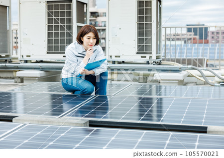 一名女工正在對太陽能電池板進行維護檢查 一名女工正在對太陽能電池板進行維護檢查 105570021