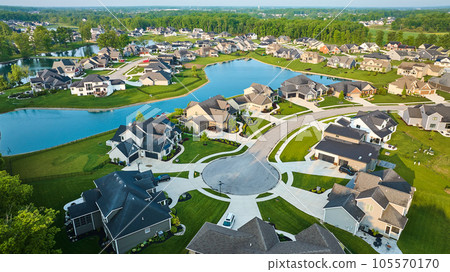 Large pond rich neighborhood cul-de-sac million-dollar mini mansion homes US houses high-end aerial 105570170