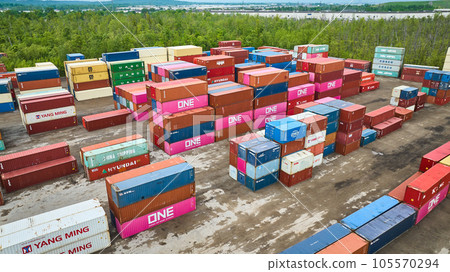 Colorful semi truck containers stacked in shipping yard, aerial shipping container port 105570294