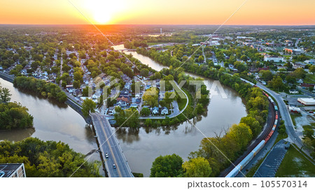 Aerial horseshoe riverbend train and small cityscape landscape village sunrise neighborhood Aerial horseshoe riverbend train and small cityscape landscape village sunrise neighborhood 105570314