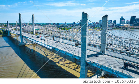 White suspension and truss bridge over Ohio River near downtown Louisville KY aerial White suspension and truss bridge over Ohio River near downtown Louisville KY aerial 105570339