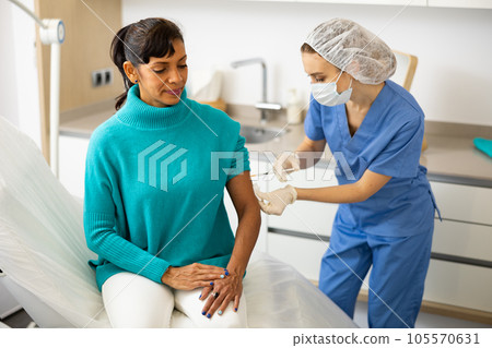 Nurse making injection of covid-19 vaccine 105570631