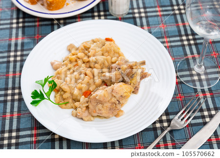 Dish of stewed rabbit with with beans and parsley Dish of stewed rabbit with with beans and parsley 105570662