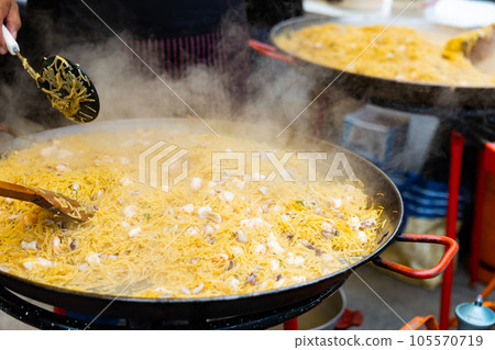 Cooking the Valencian dish Fideua de Marisco 105570719