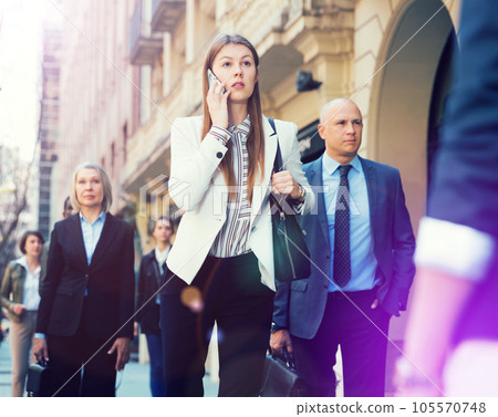 Young business woman talking on phone outdoors Young business woman talking on phone outdoors 105570748