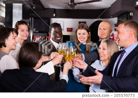 Colleagues clinking glasses of champagne on corporate party 105570773