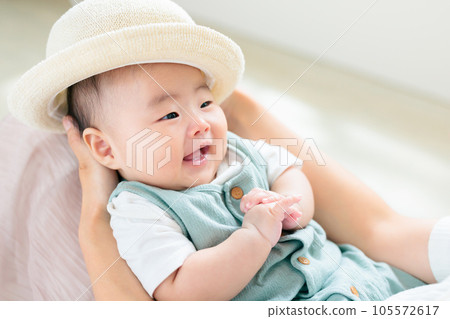 A smiling baby wearing a hat ready to go out UV protection 105572617