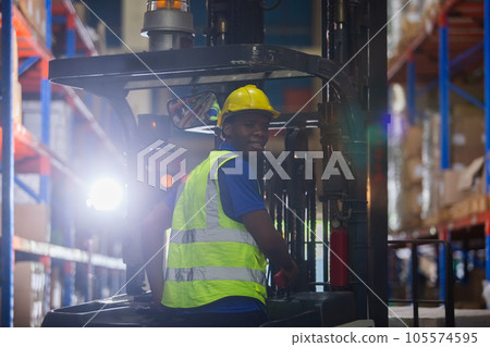 Man african american wear safety helmet driver forklift warehouse in factory. 105574595