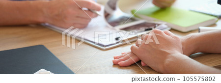 Doctor checking patient ultrasound scan results at his desk. Doctor checking patient ultrasound scan results at his desk. 105575802