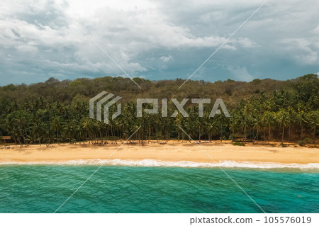 Beautiful Sandy Beach Resort With Palm Trees and Sea Surf with Waves. Silent Beach, Sri Lanka. Beautiful Sandy Beach Resort With Palm Trees and Sea Surf with Waves. Silent Beach, Sri Lanka. 105576019