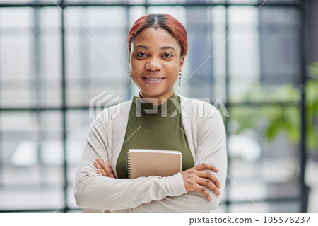 Close-up photo of a pretty, pensive dark-skinned girl, student, manager, secretary, freelancer 105576237