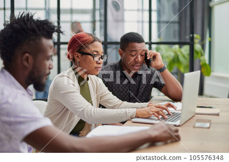 In a modern office. a diverse team of managers at a company meeting to discuss business projects. In a modern office. a diverse team of managers at a company meeting to discuss business projects. 105576348