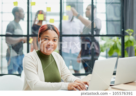 Cropped shot of an attractive young businesswoman working in her office. 105576391