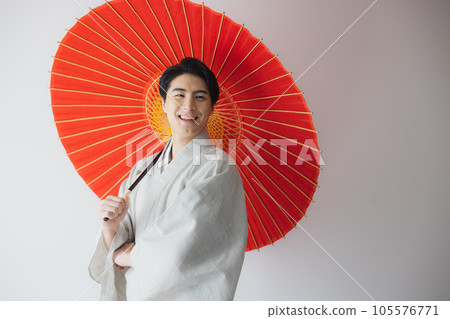 A man in a kimono, a Japanese umbrella A man in a kimono, a Japanese umbrella 105576771