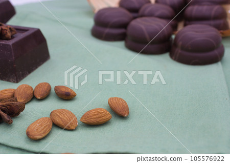 chocolate candies with almonds on a green background 105576922