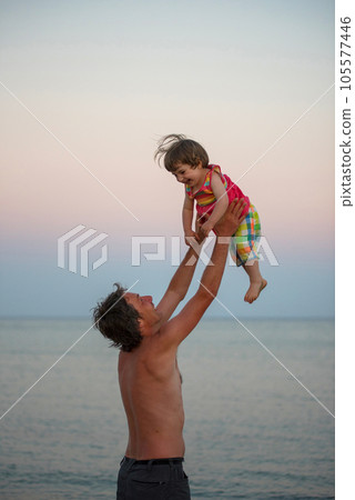 Father and daughter having fun at beach 105577446