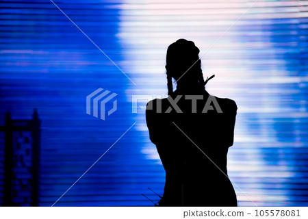 Silhouette of an artist singing live on the stage 105578081