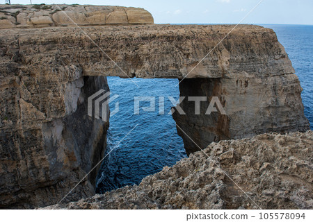 Wied il Mielah canyon, natural arch over the sea. Gozo, Malta 105578094