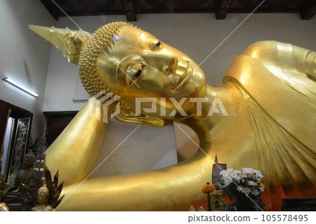 The golden reclining Buddha on a Buddhism Church at Wat Pra Pathom Jedi is a largest Pagoda in Nakhon Pathom Province , Middle of Thailand. The golden reclining Buddha on a Buddhism Church at Wat Pra Pathom Jedi is a largest Pagoda in Nakhon Pathom Province , Middle of Thailand. 105578495
