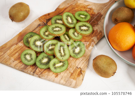 Fresh Sliced organic kiwi on wooden cutting board 105578746