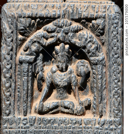 Small carved sitting Buddha on a wooden column in Nepal Small carved sitting Buddha on a wooden column in Nepal 105579800